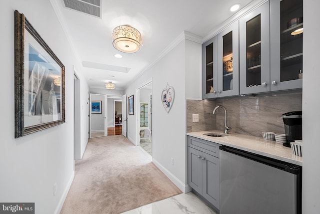 hallway with visible vents, light carpet, a sink, crown molding, and baseboards