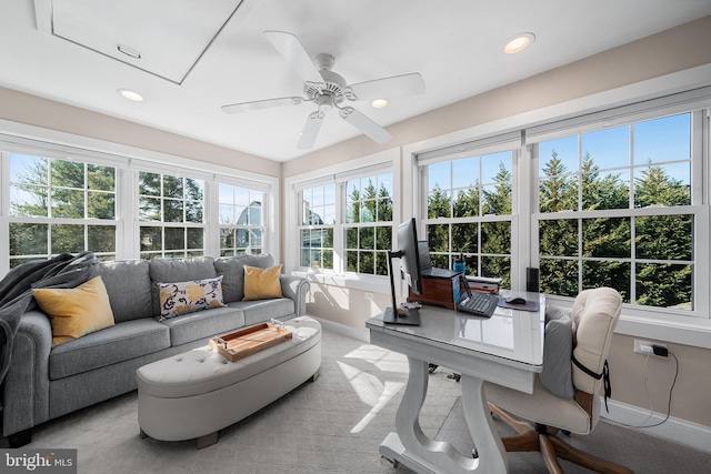 sunroom / solarium with a ceiling fan