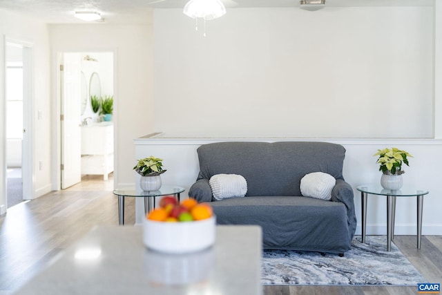 sitting room featuring baseboards and wood finished floors