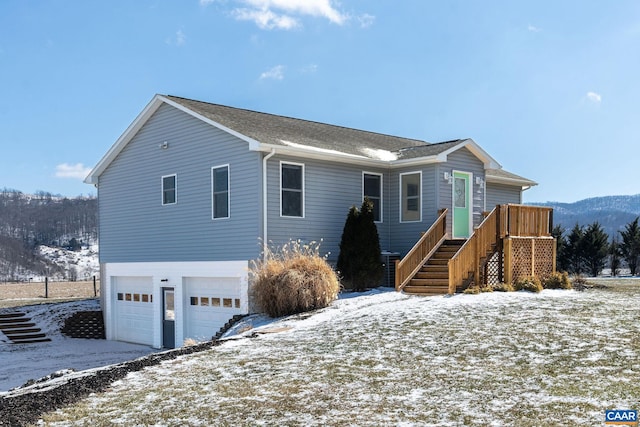 view of front of house featuring a garage and stairway