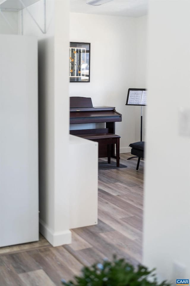 interior space with baseboards and wood finished floors