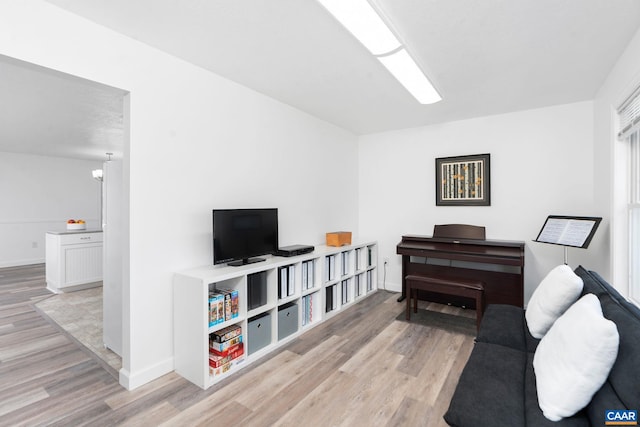 sitting room featuring baseboards and wood finished floors