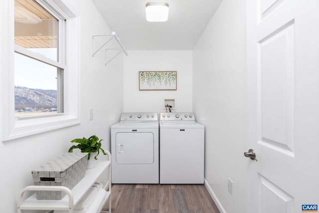 washroom with laundry area, baseboards, separate washer and dryer, and wood finished floors