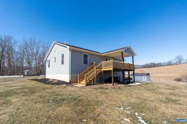 exterior space featuring an outbuilding, a yard, stairway, a storage shed, and a wooden deck