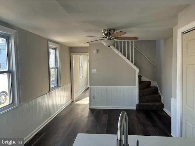 interior space featuring a wealth of natural light, visible vents, baseboards, and wood finished floors