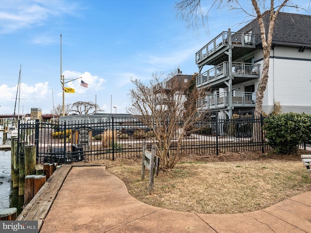 view of home's community with fence