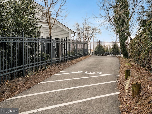 uncovered parking lot featuring fence