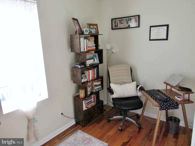 office space featuring baseboards and wood finished floors