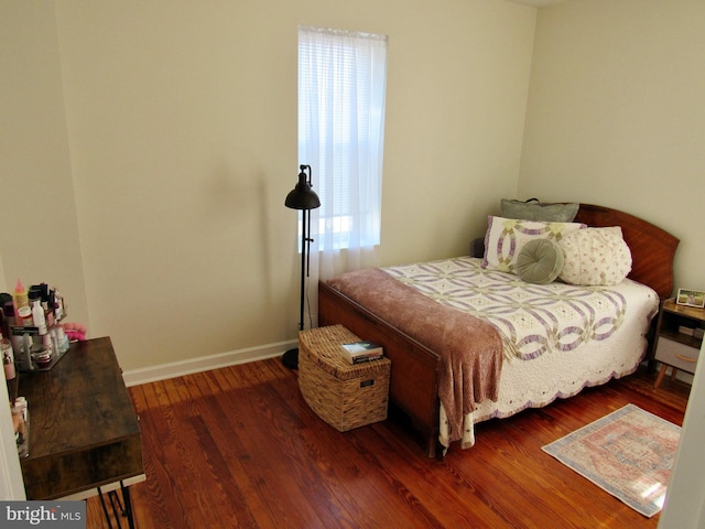 bedroom featuring dark wood-style floors and baseboards