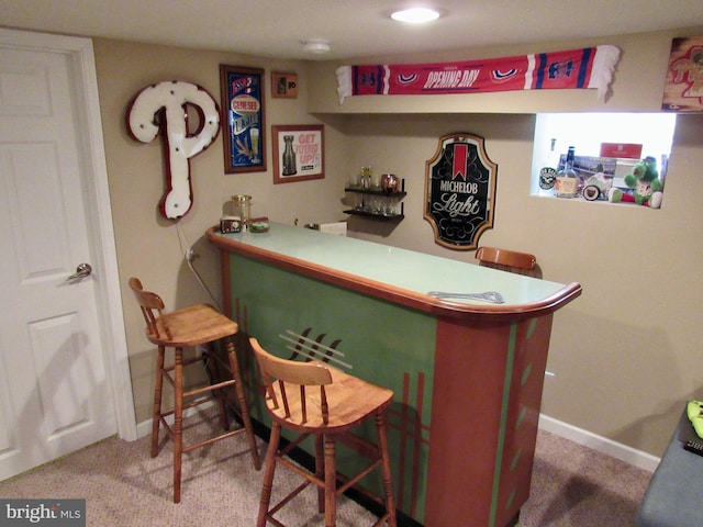 bar featuring a dry bar, carpet, and baseboards