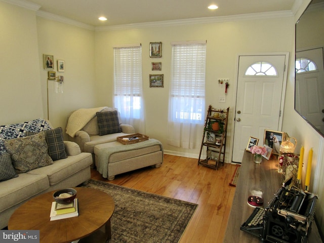 living room featuring recessed lighting, crown molding, and hardwood / wood-style floors