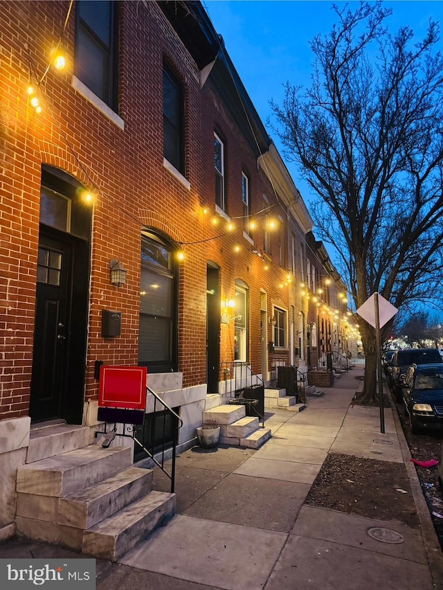 view of home's exterior featuring entry steps and brick siding