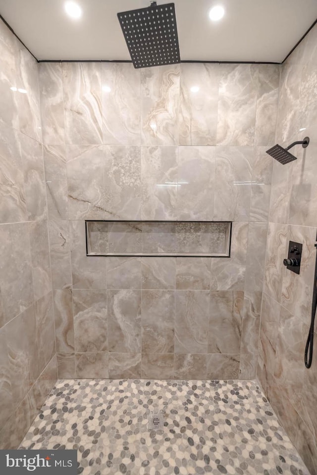 full bathroom with a tile shower