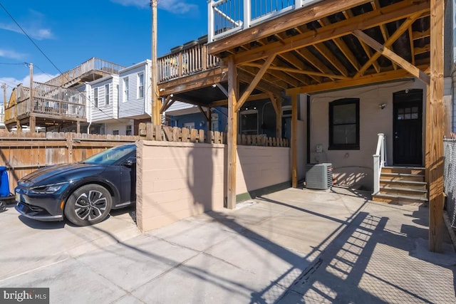 view of patio featuring entry steps and fence