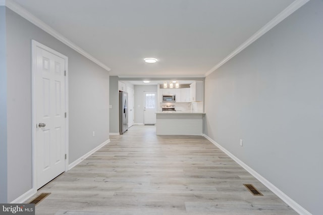 interior space featuring light wood-type flooring, visible vents, and crown molding