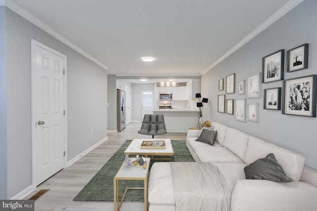 living area featuring light wood-type flooring, visible vents, ornamental molding, and baseboards