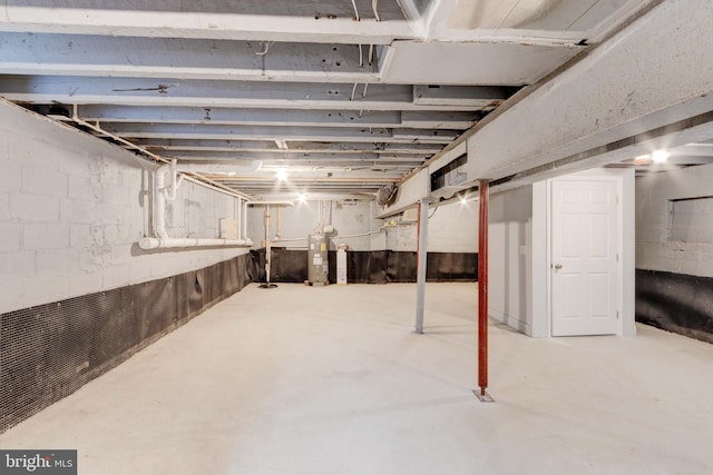 unfinished basement featuring electric water heater