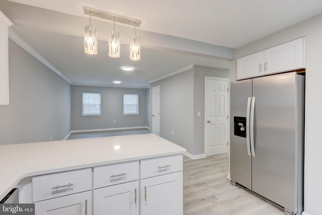 kitchen featuring white cabinets, ornamental molding, decorative light fixtures, light countertops, and stainless steel refrigerator with ice dispenser