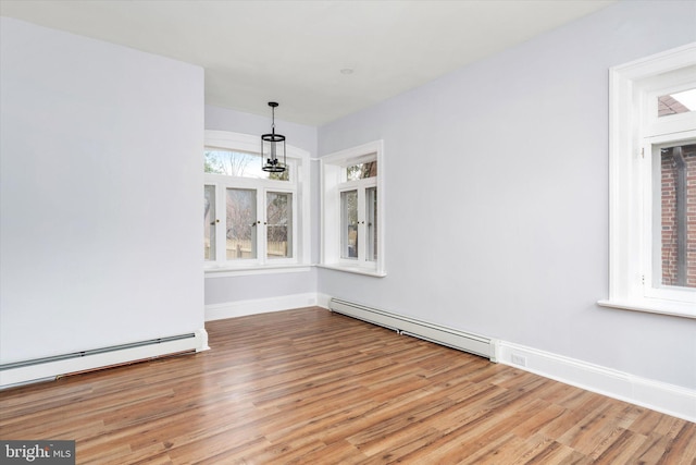 117 Morningside Dr, Trenton, NJ 08618 - unfurnished dining area featuring baseboard heating, light wood-type flooring, and baseboards