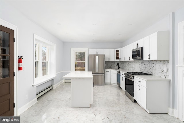 117 Morningside Dr, Trenton, NJ 08618 - kitchen featuring a baseboard radiator, stainless steel appliances, light countertops, a center island, and glass insert cabinets