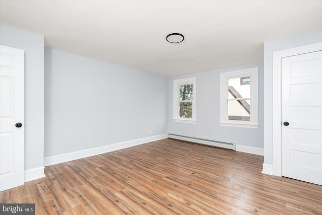 117 Morningside Dr, Trenton, NJ 08618 - unfurnished room featuring a baseboard heating unit, wood finished floors, and baseboards