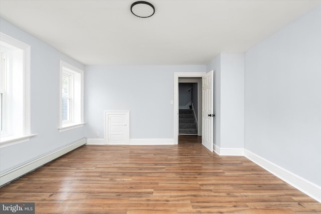 117 Morningside Dr, Trenton, NJ 08618 - spare room with a baseboard heating unit, light wood-style floors, baseboards, and stairs