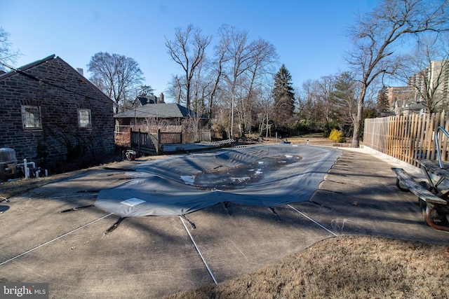 view of pool with a fenced in pool, a patio area, fence, and a deck