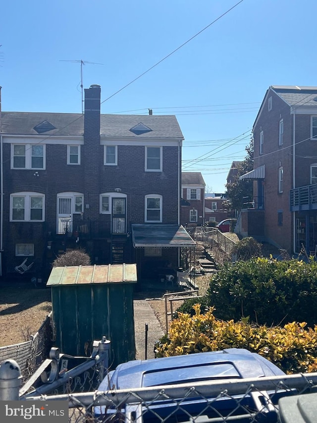 back of property with a chimney