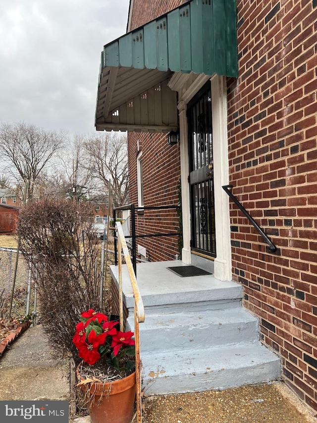 entrance to property with brick siding