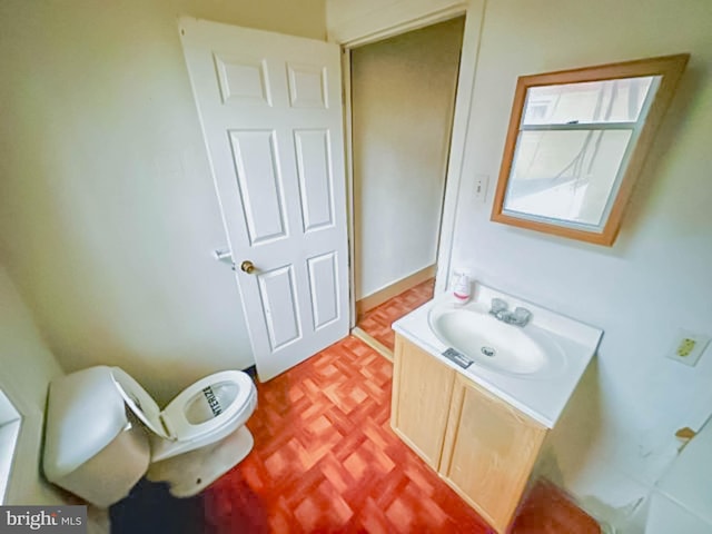 bathroom featuring toilet and vanity