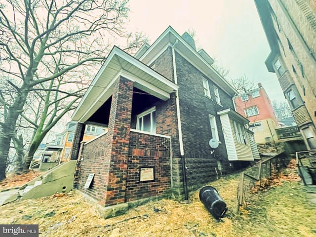 view of side of home with brick siding