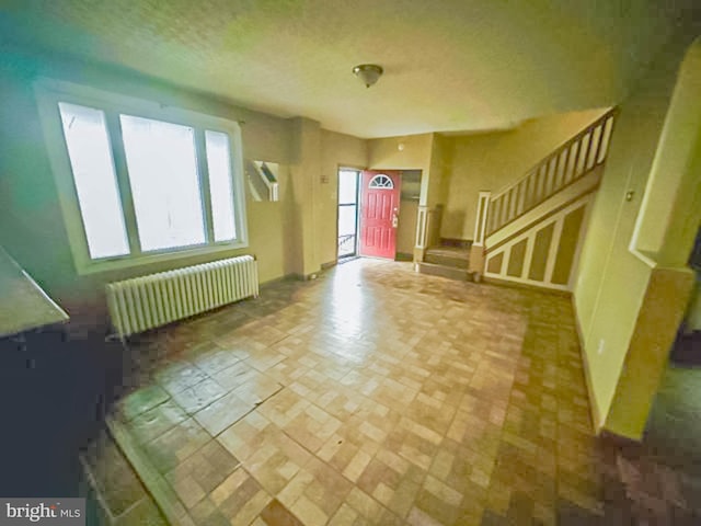 interior space featuring stairs and radiator heating unit