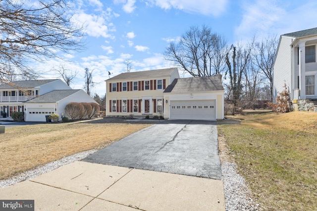 view of front facade featuring a garage, driveway, and a front lawn