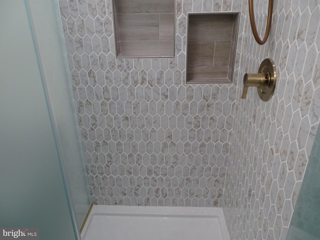 bathroom with tiled shower