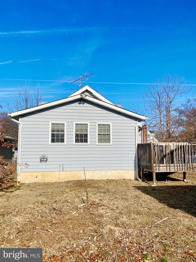 view of property exterior with a deck