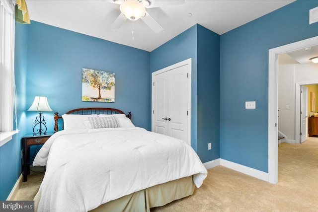 bedroom featuring light carpet, visible vents, baseboards, and a closet