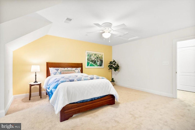 bedroom with light colored carpet, visible vents, attic access, ceiling fan, and baseboards