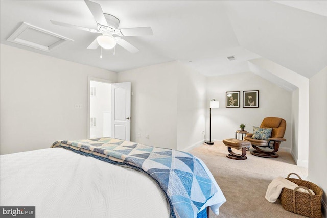 carpeted bedroom featuring lofted ceiling, attic access, baseboards, and ceiling fan