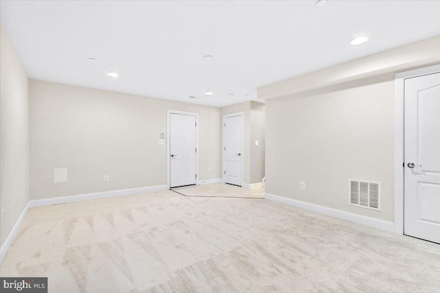 unfurnished room featuring light carpet, recessed lighting, visible vents, and baseboards