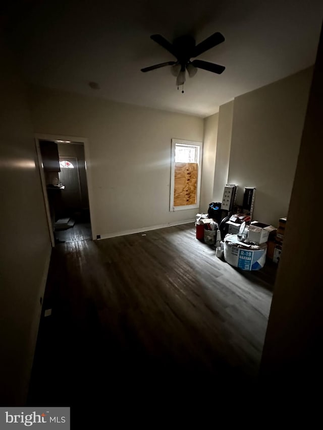 bedroom featuring ceiling fan, baseboards, and wood finished floors