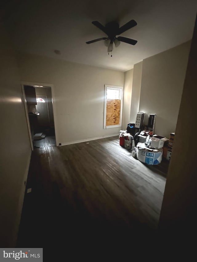 bedroom with ceiling fan, baseboards, and wood finished floors