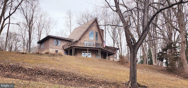 back of house featuring a deck