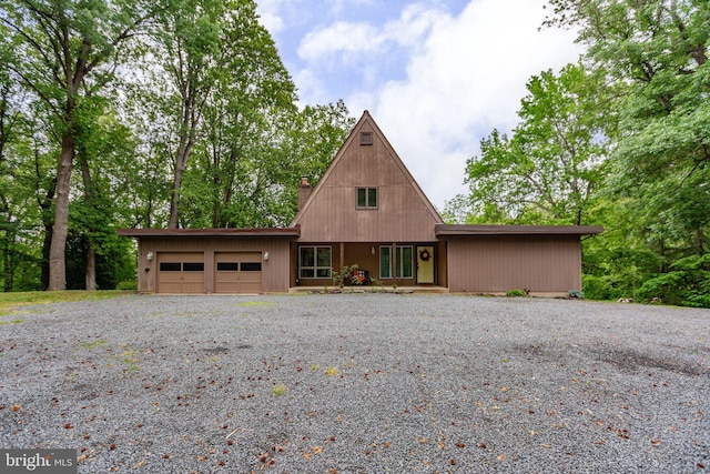 15431 Machodoc Dr, King George, VA 22485 - a-frame style home featuring a garage, driveway, and a chimney