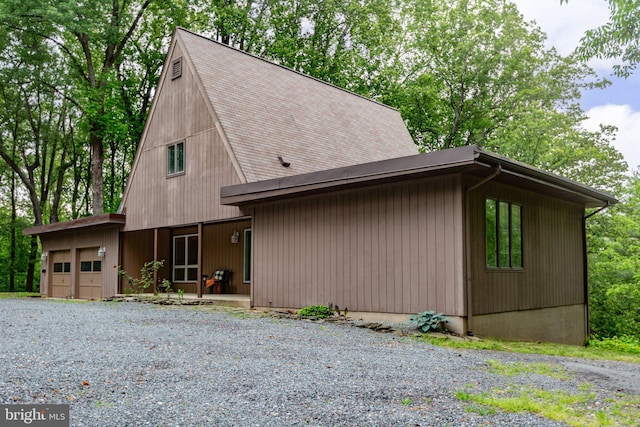15431 Machodoc Dr, King George, VA 22485 - view of front of home with an attached garage, roof with shingles, and gravel driveway
