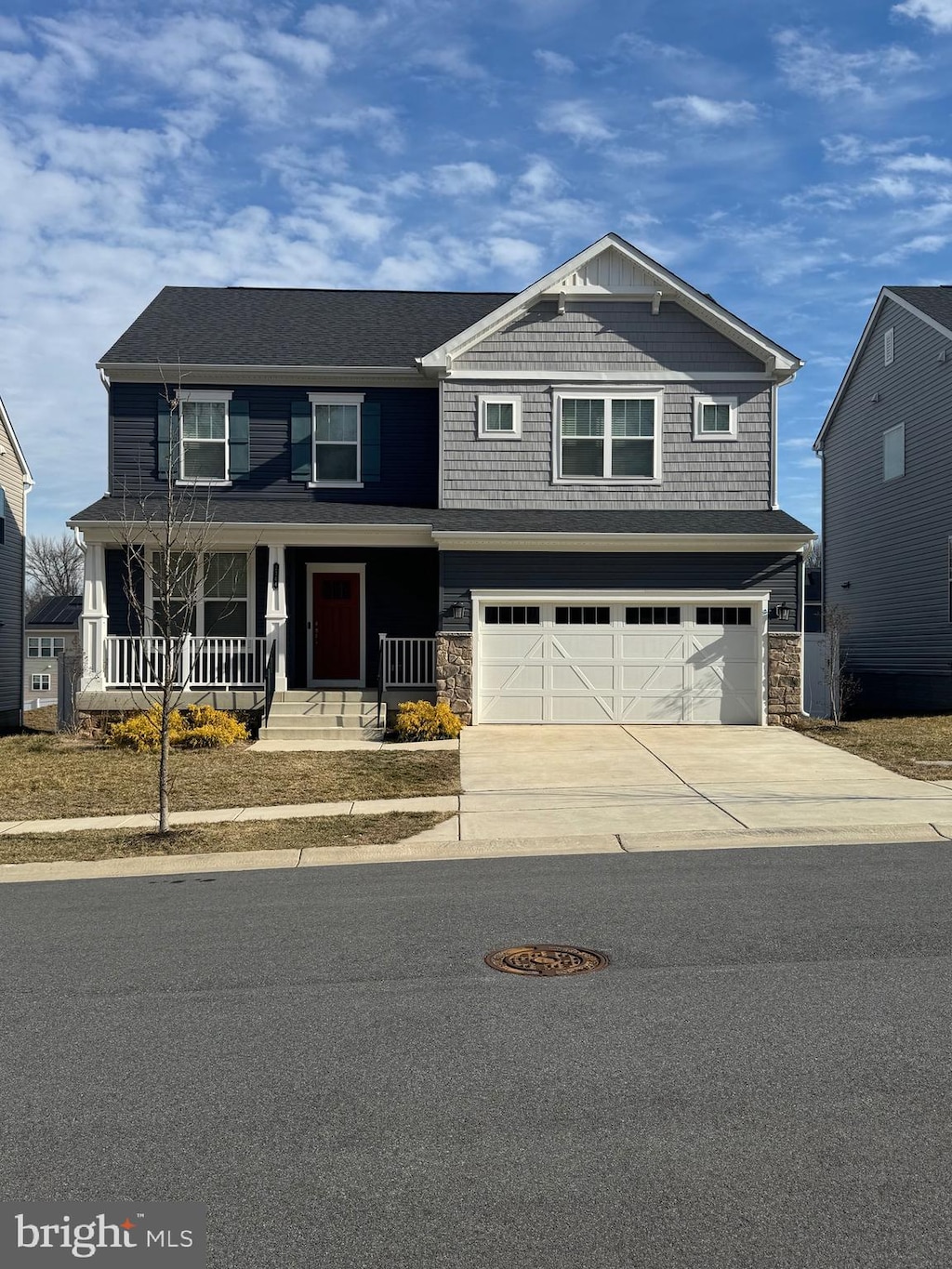 craftsman inspired home featuring stone siding, covered porch, concrete driveway, and a garage