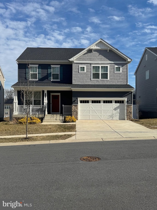 craftsman house featuring covered porch, stone siding, concrete driveway, and an attached garage