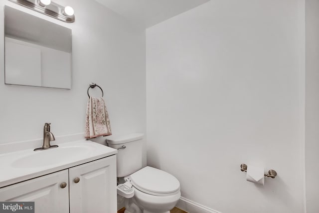 bathroom featuring toilet and vanity