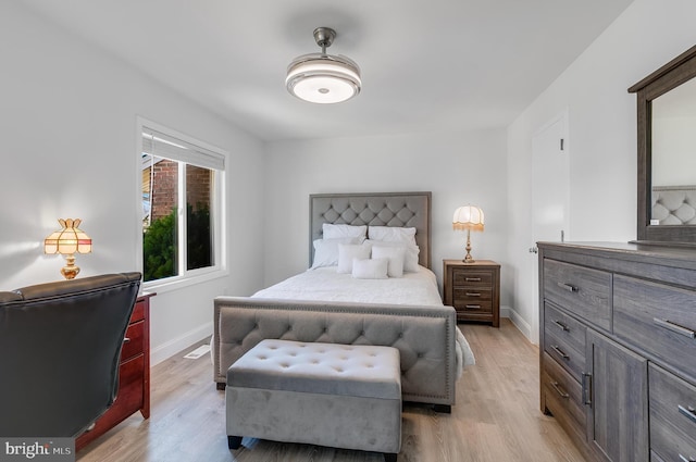 bedroom featuring light wood-style floors and baseboards