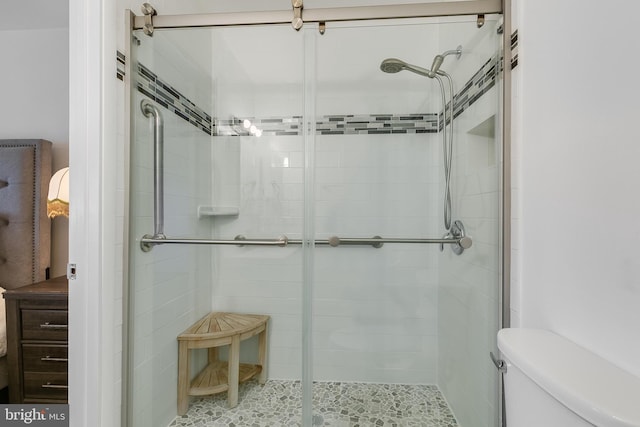 full bathroom with a shower stall and toilet