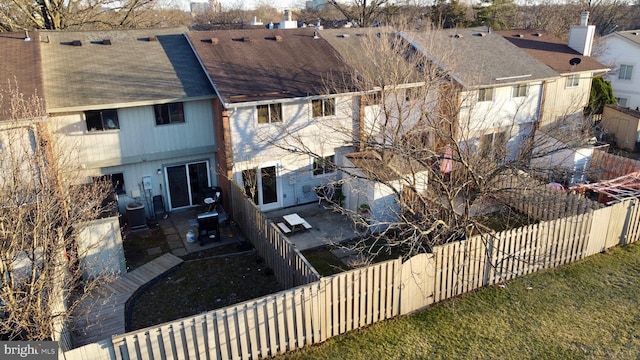 back of house featuring a patio, a shingled roof, a fenced backyard, and central air condition unit